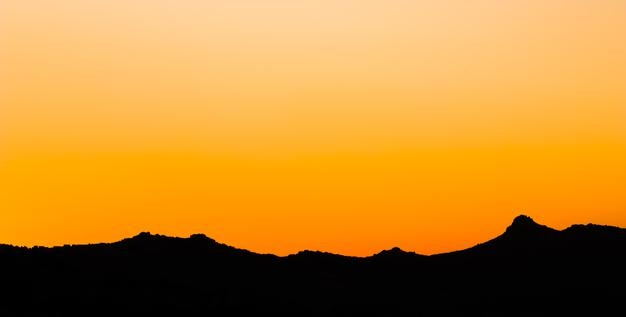 Background from a beautiful colorful sunset with the silhouette of the mountains high quality photo