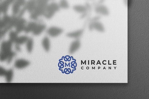 Clean logo mockup in white pressed paper with plant shadow