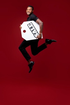 full shot man jumping with sale tag
